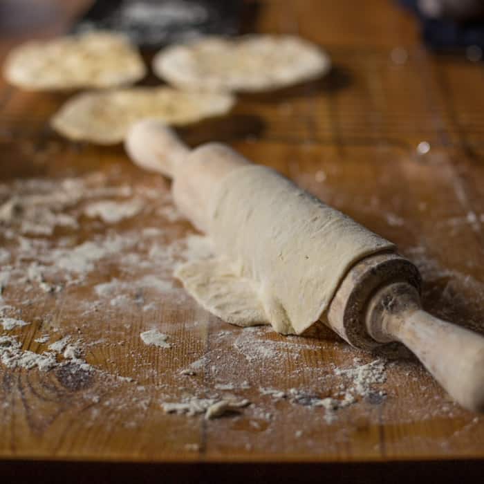 Campfire Chapati Flatbread on a cooling rack with a floury rolling pin