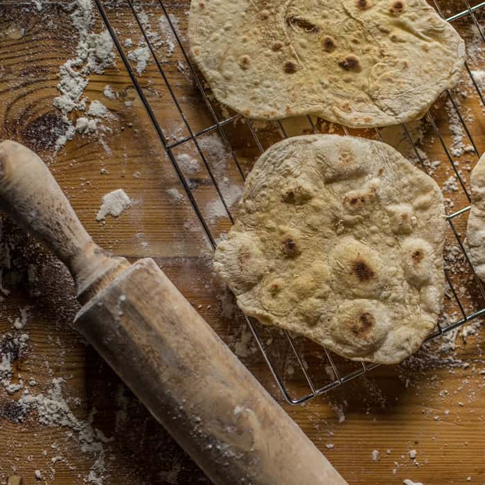 Campfire Chapati Flatbread on a cooling rack with a floury rolling pin