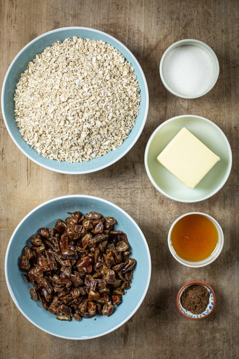 Bowls of ingredients for how to make the best flapjacks ever: includes oats, dates, butter, sugar, syrup and spice