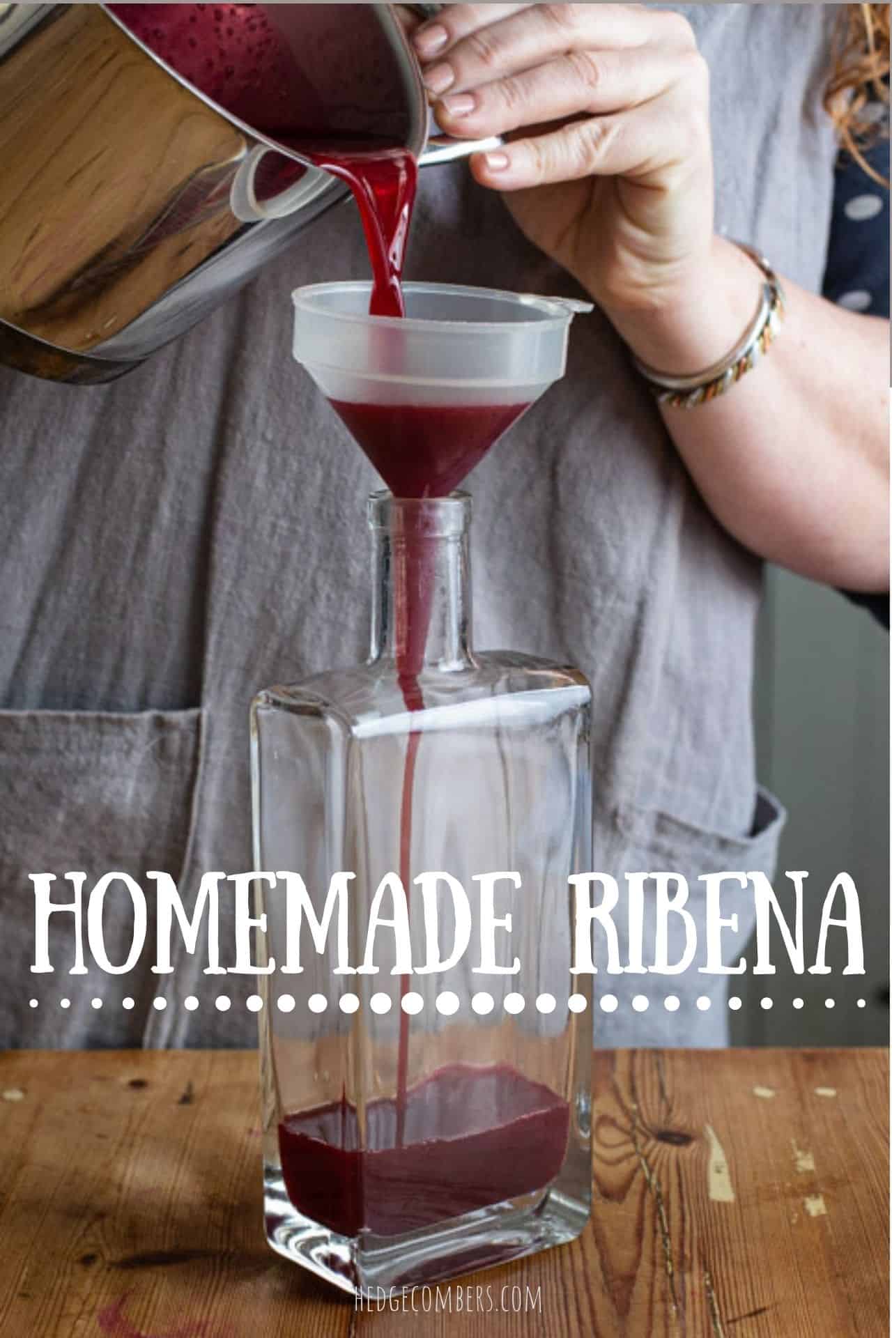 woman in grey apron pouring blackcurrants syrup from a silver pan, into a plastic funnel over a glass bottle