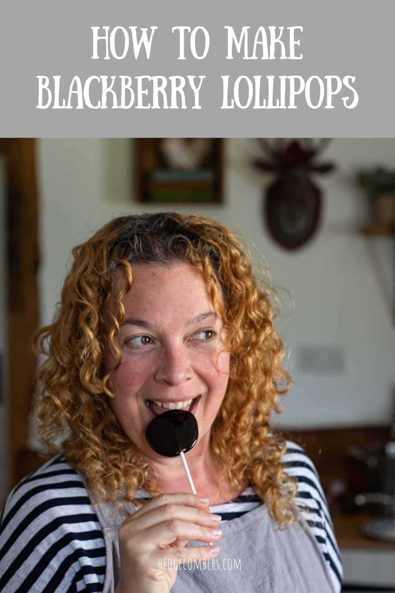 woman with red curly hair eating a homemade blackberry lollipop