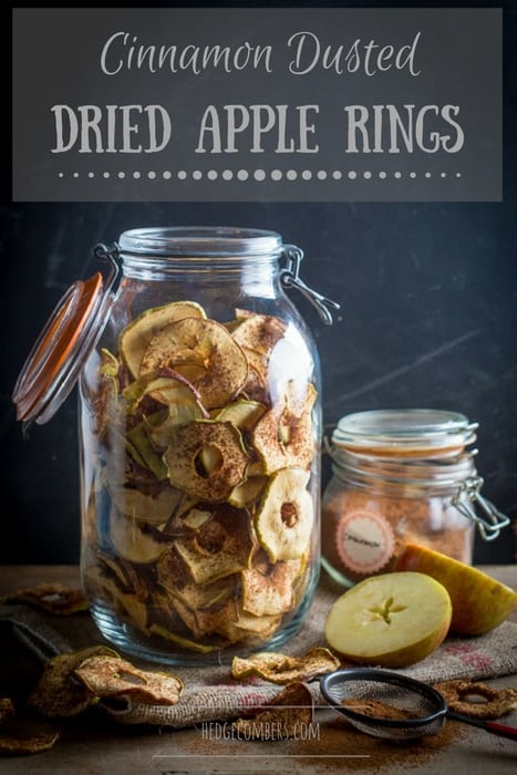 Glass jar filled with dried apple rings that have been dusted with cinnamon