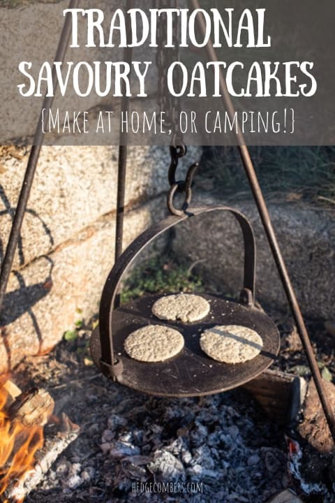 cast iron griddle hanging from a hook over a campfire with 3 homemade oatcakes cooking on the hot plate 