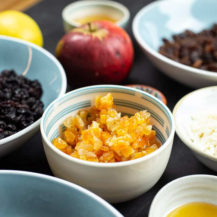 Small bowl of mixed peel surrounded by other bowls of ingredients