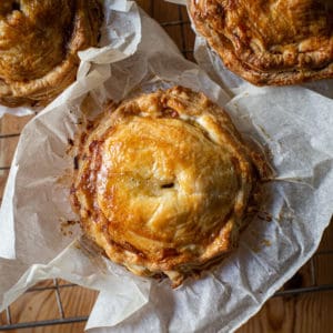 Three baked turkey leftovers pies in baking paper