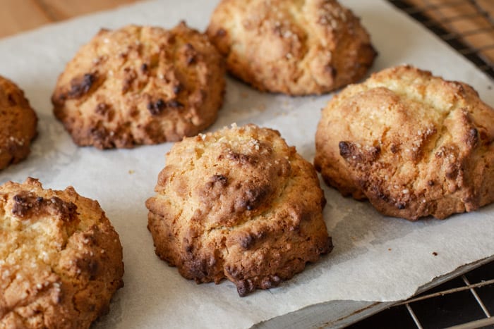 freshly baked coconut rock cakes on a baking sheet