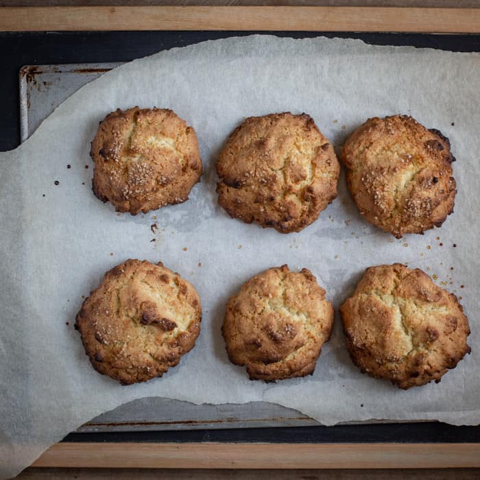 freshly baked coconut rock cakes on a baking sheet