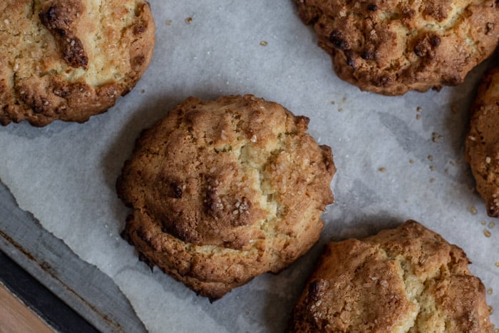 freshly baked coconut rock cakes on a baking sheet