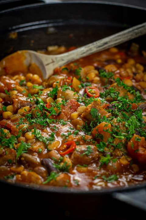 Cowboy stew in a pan with a wooden spoon