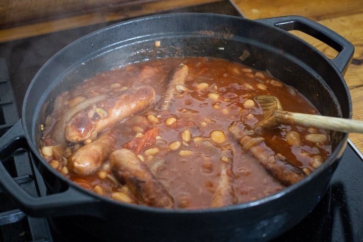 a black cast iron pan of cowboy stew simmering on the stove
