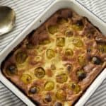 enamel dish of plum and cardamom clafoutis