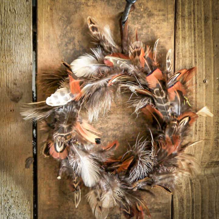 hand made pheasant feather wreath against wooden barn door