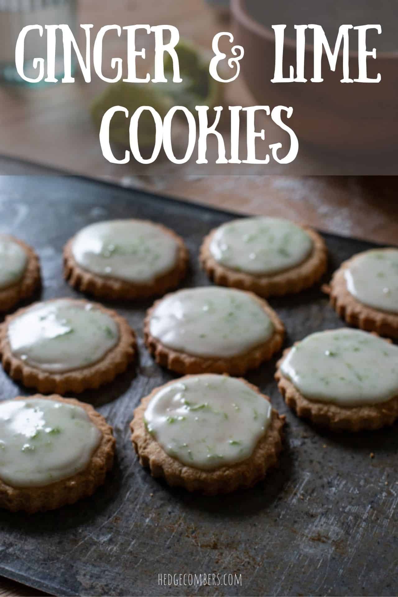 dark grey baking sheet topped with several iced ginger cookies on a wooden counter