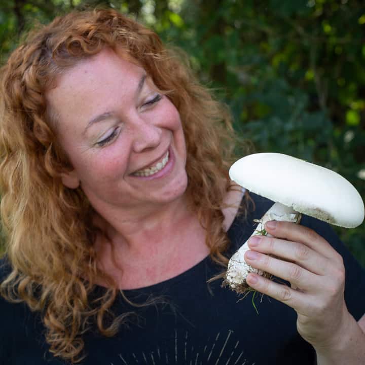 Smiling woman holding a wild horse mushroom