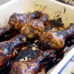 A baking tray of sticky, balsmaic glazed chicken drumsticks