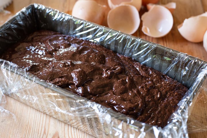 silver loaf pan filled with chocolate marquise mixture ready to go into the freezer