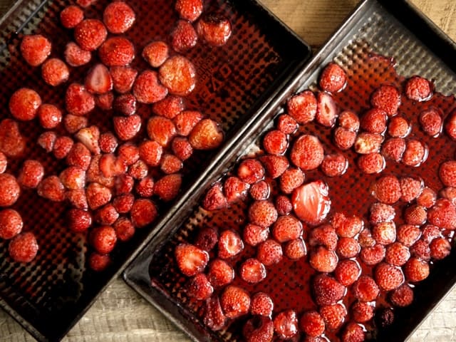  2 pans  of Hot Roast Strawberries on a kitchen table top