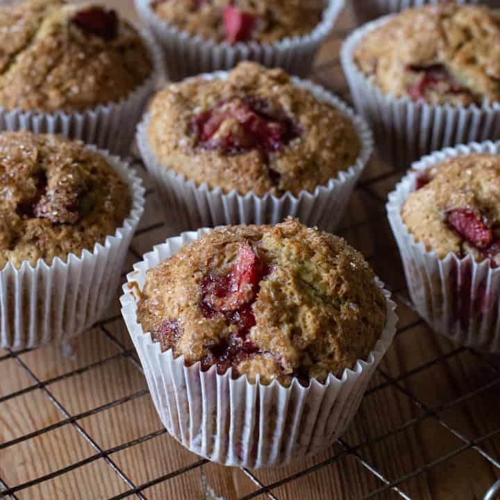 several strawberry muffins on a metal cooling rack