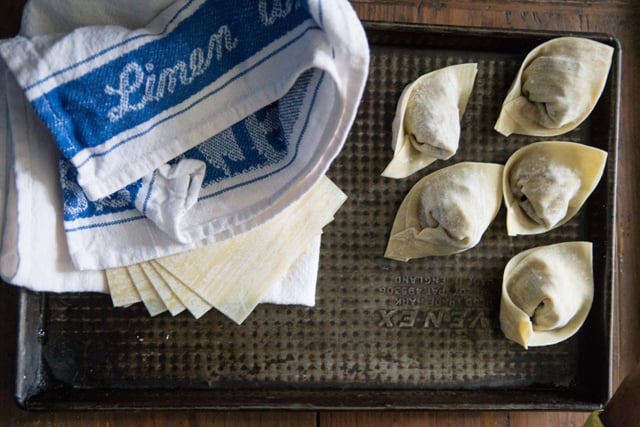 Vegetarian wontons on a tray waiting to be cooked 