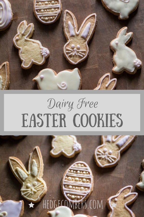  Dairy Free Easter cookies in the shape of rabbits, eggs and chicks, laid out on a wooden board