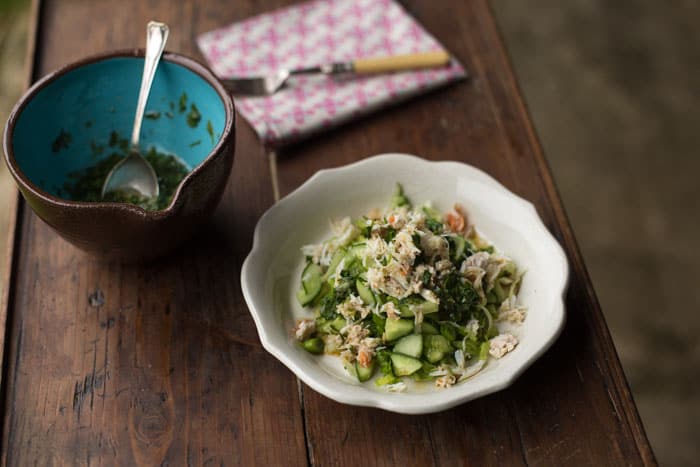Small white bowl with Asian Crab Salad and a second bowl with a coriander dressing