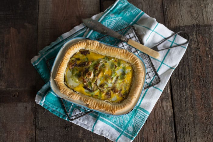  Leek and Smoked Mackerel Quiche on a cloth with a knife beside
