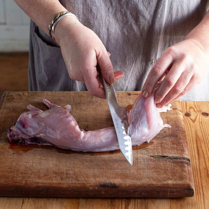 womans hands butchering a wild rabbit