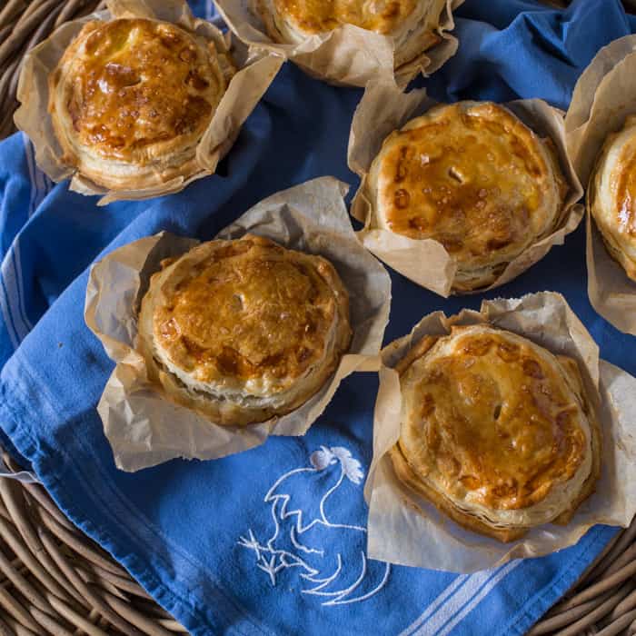 Chilli Beef Pies on a blue cloth in a wicker basket