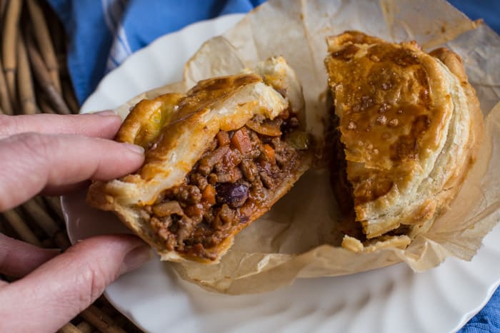 Chilli Beef Pies cut in half to show the filling 