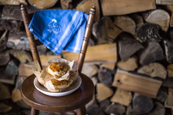 Chilli Beef Pies on a white plate with a blue cloth on a wooden chair