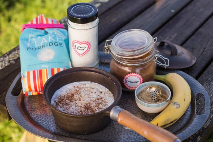 Gluten free camping breakfast -Coconut Rice Pudding ingredients on a metal tray on a wooden table