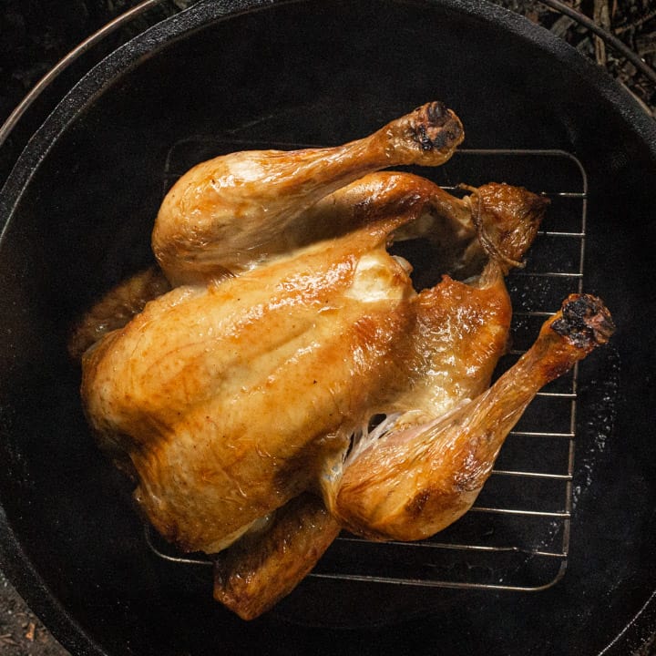 golden roast chicken in a dutch oven