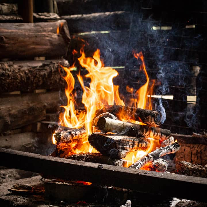 campfire flames burning in an outdoor kitchen