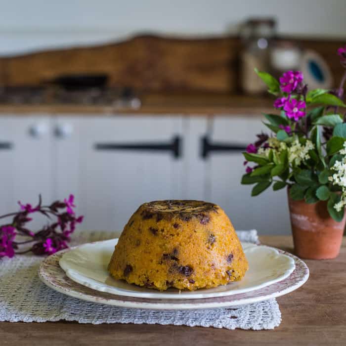 Snowdon Pudding on a serving dish with a plant beside it