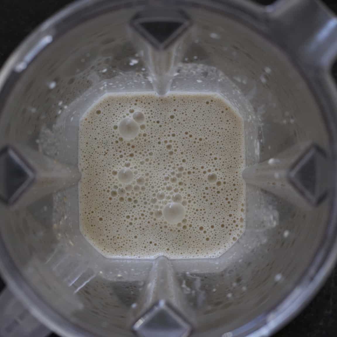 Inside shot of a blender with a creamy looking smoothie