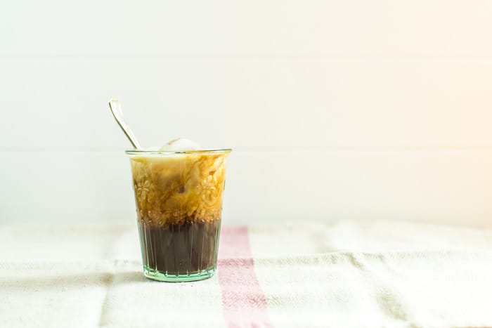 Easy Iced Coffee in a glass with a sppon on a pink and white check cloth