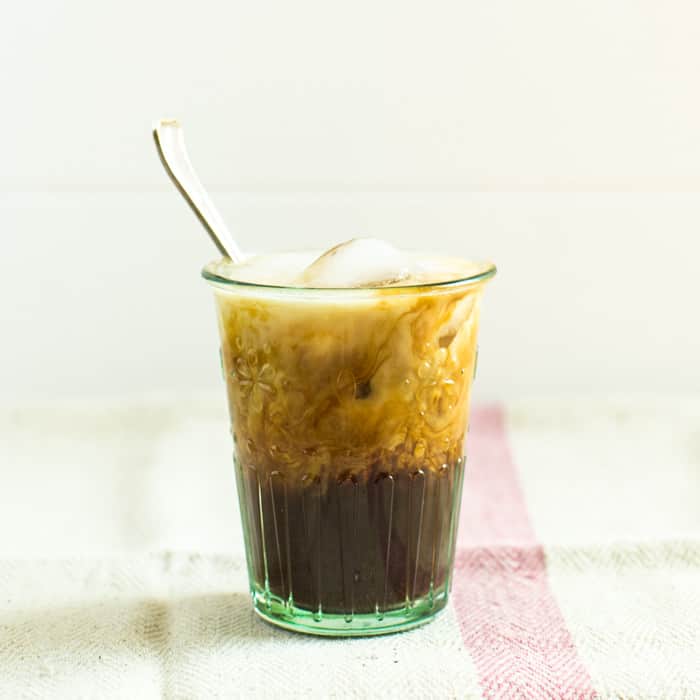 Easy Iced Coffee in a glass with a sppon on a pink and white check cloth