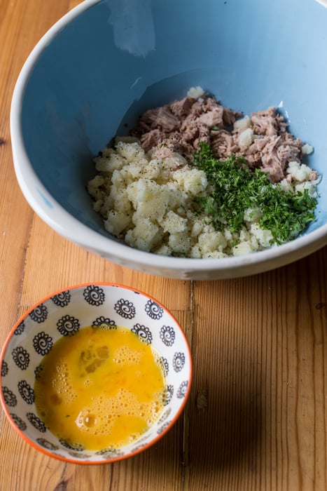 ingredients for Crispy Fish Balls with Easy Tartare Suace in a blue bowl beside a patterened bowl of beaten egg