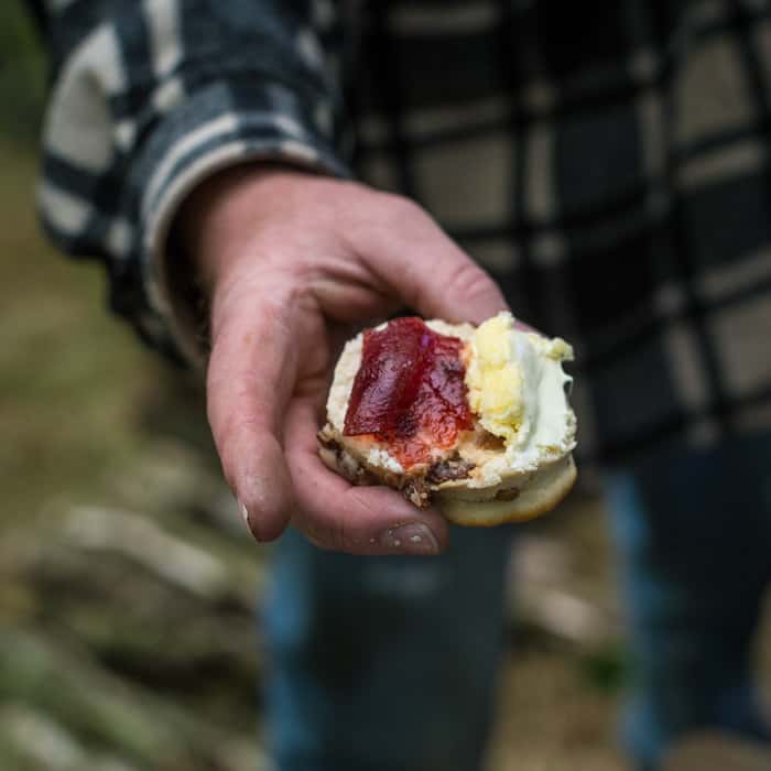 jam and clotted cream scone held by Johnny desert after Spicy n'duja meatballs