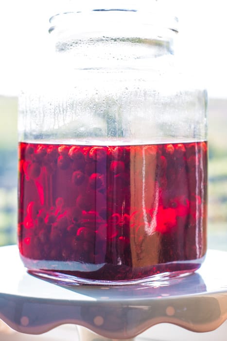 Jar of homemade cassis with blackcurrants 