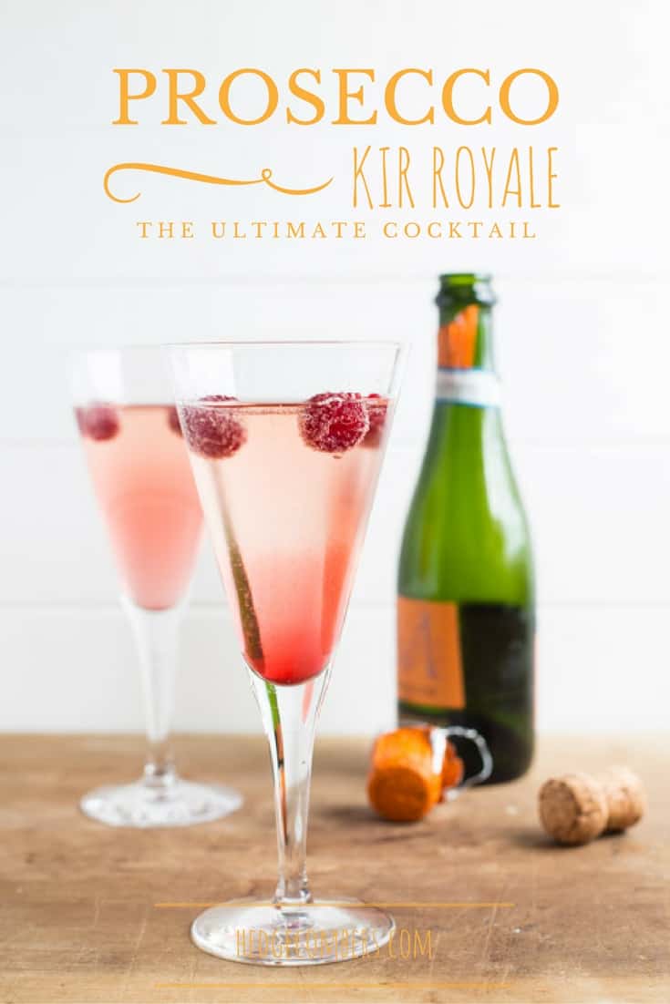 Prosecco bottle and glasses filled with pretty Kir Royale recipe and raspberries