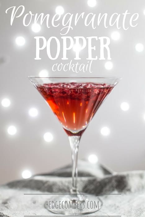  A cocktail glass of Pomegranate Popper Cocktail on a silver cloth