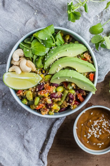 Vegan Buddha Bowl with Spicy Peanut Dressing on a white cloth