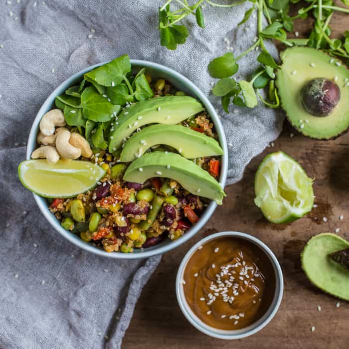 Vegan Buddha Bowl with Spicy Peanut Dressing on a white cloth