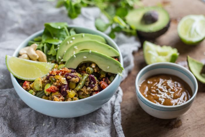 Vegan Buddha Bowl with Spicy Peanut Dressing on a white cloth