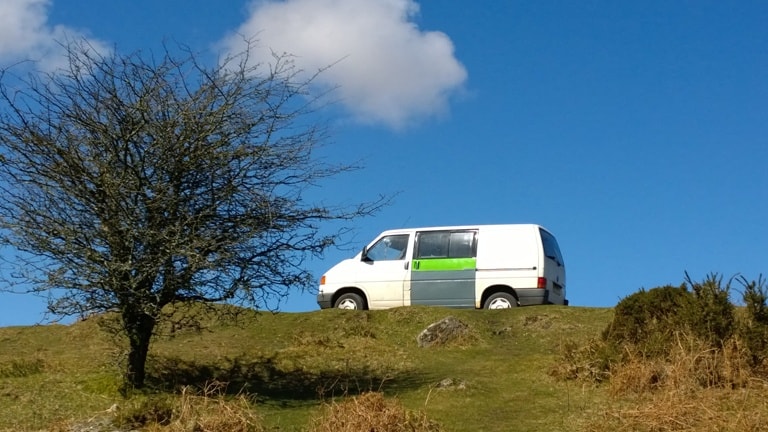 VW T4 before restoration against a deep blue Cornish sky