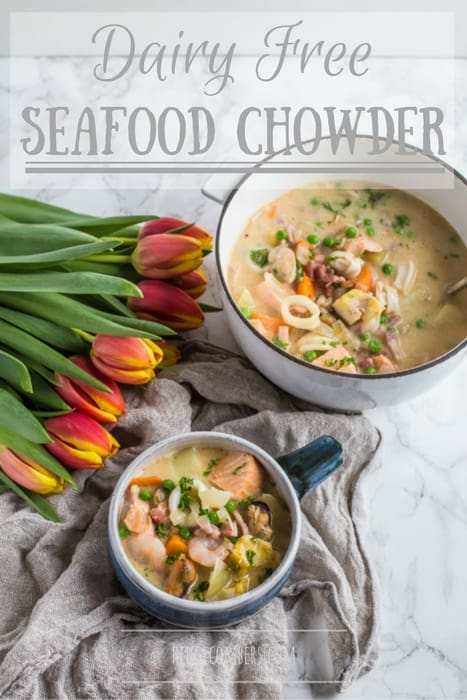 Dairy Free Seafood Chowder in bowls with tulips on a grey cloth