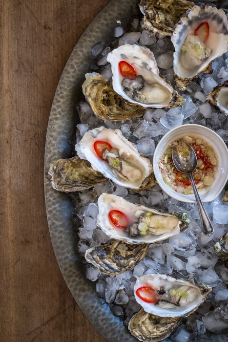 Seafood Brassiere, open Oysters with lemon. Isolated, white