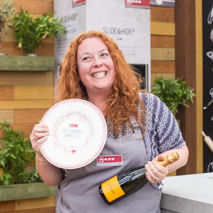 Jane (hedgecomber) Sarchet Neff Cookaholic Winner 2017, holding a bottle of champagne and winners plate