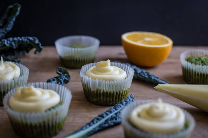 Pretty green kale cupcakes with swirls of orange frosting